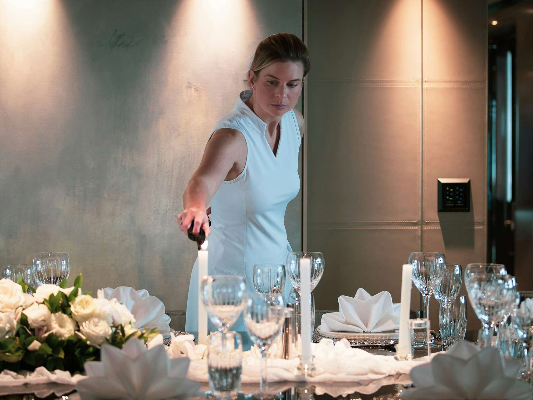 Concierge-Services_Yacht Setup Stewardess setting up dining table for guests