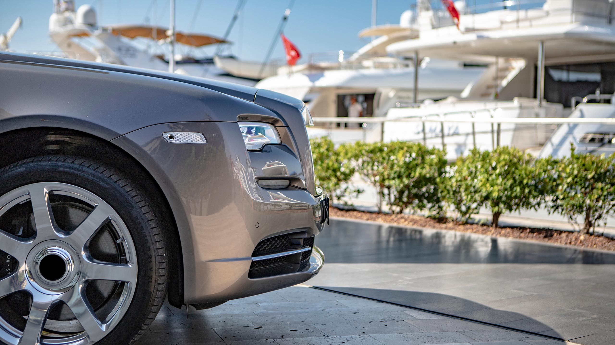 Luxury car parked at superyacht marina