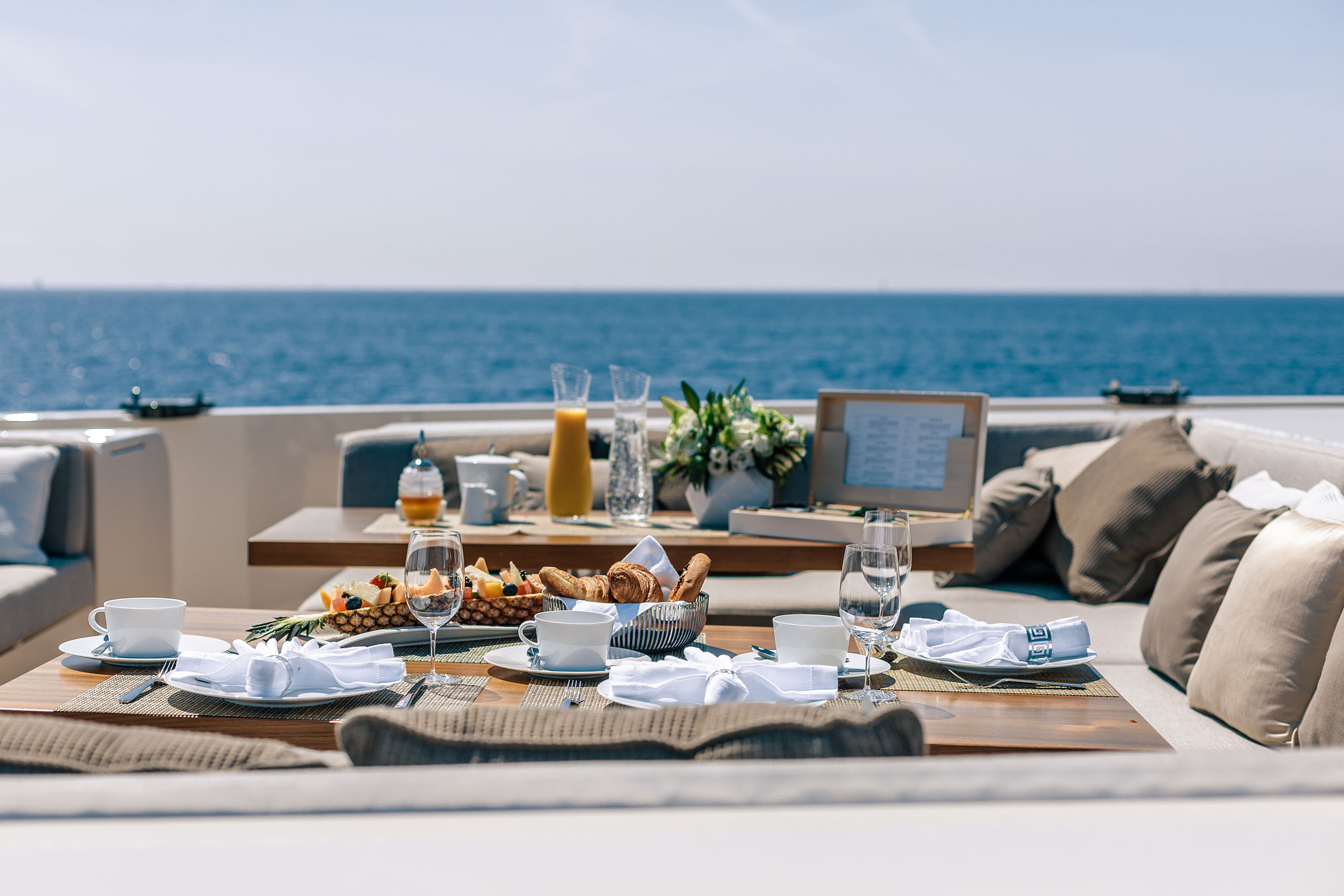 Table set for alfresco breakfast during yacht charter