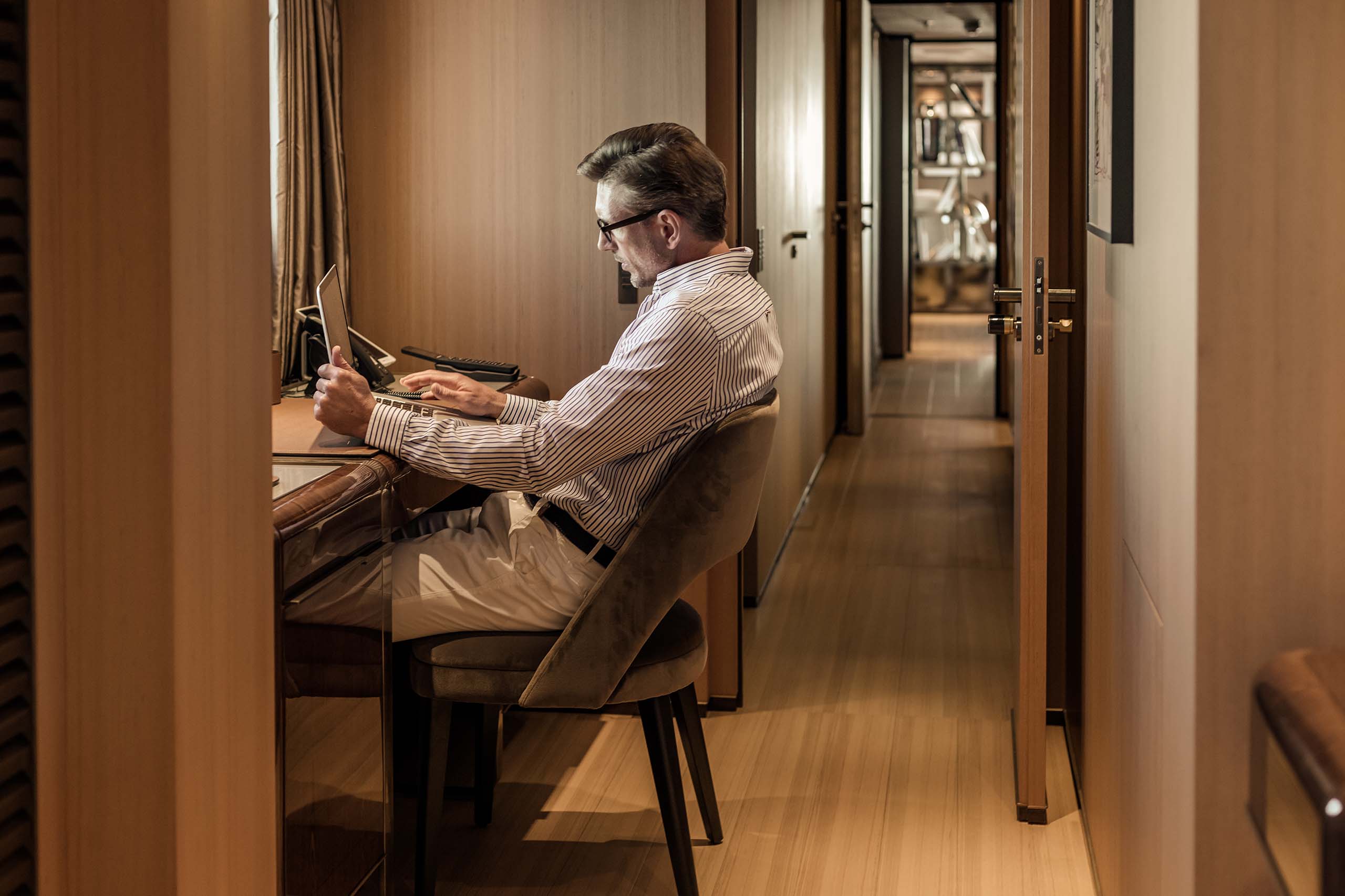 Yacht owner reviewing financial report on board superyacht