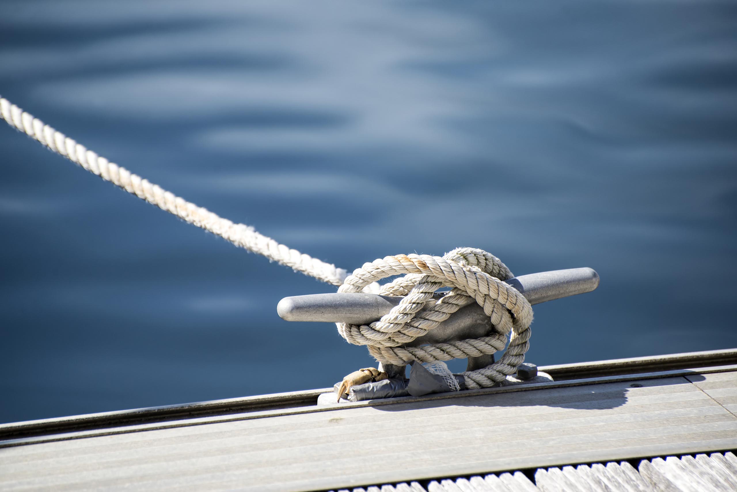 Marine rope tied on cleat at dock