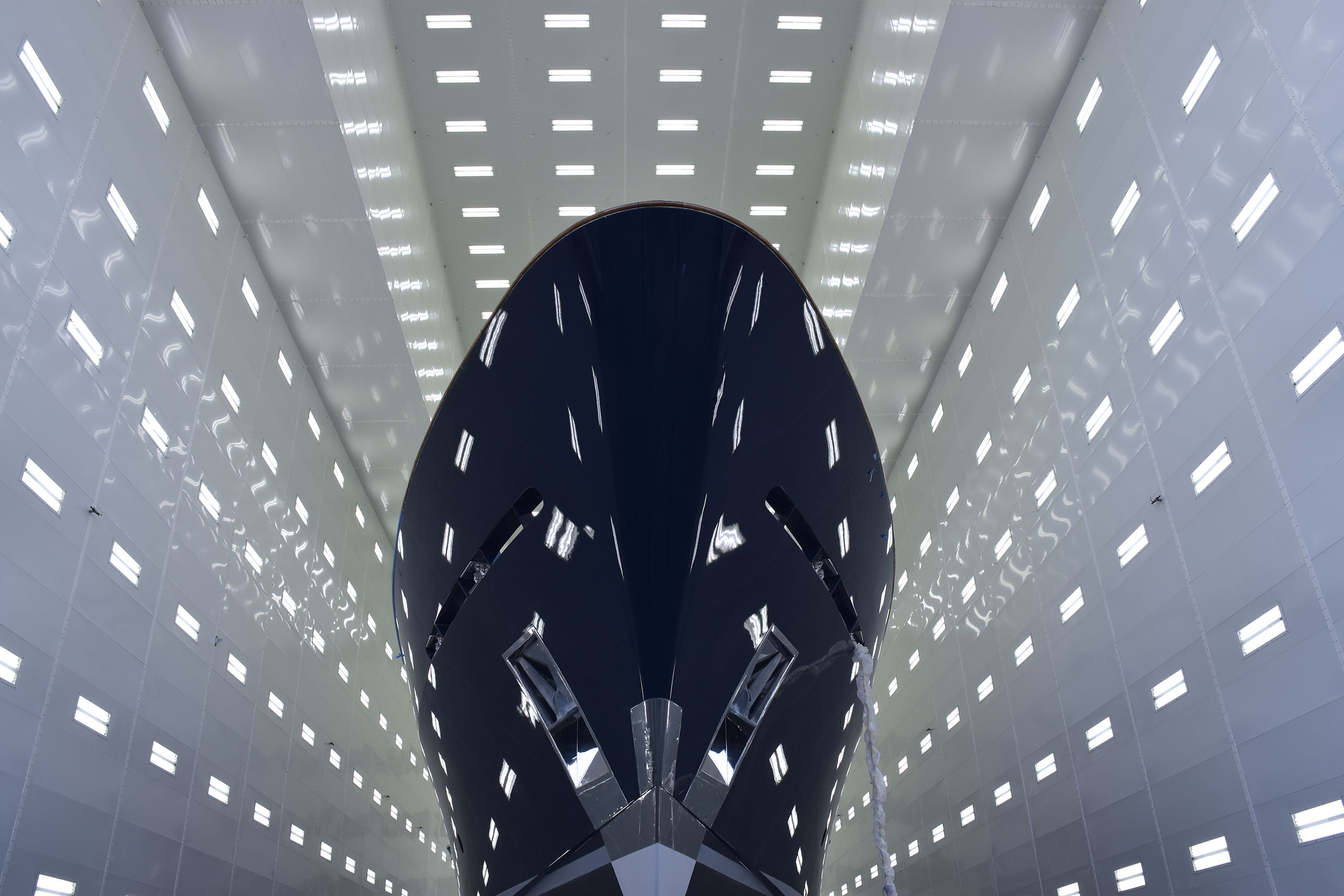 Yacht photographed out of the water inside painting facility