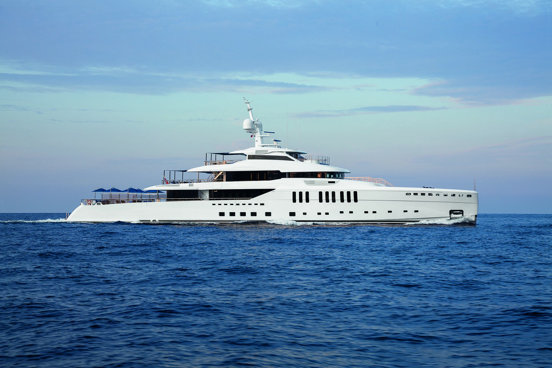 Profile shot of white mega yacht cruising